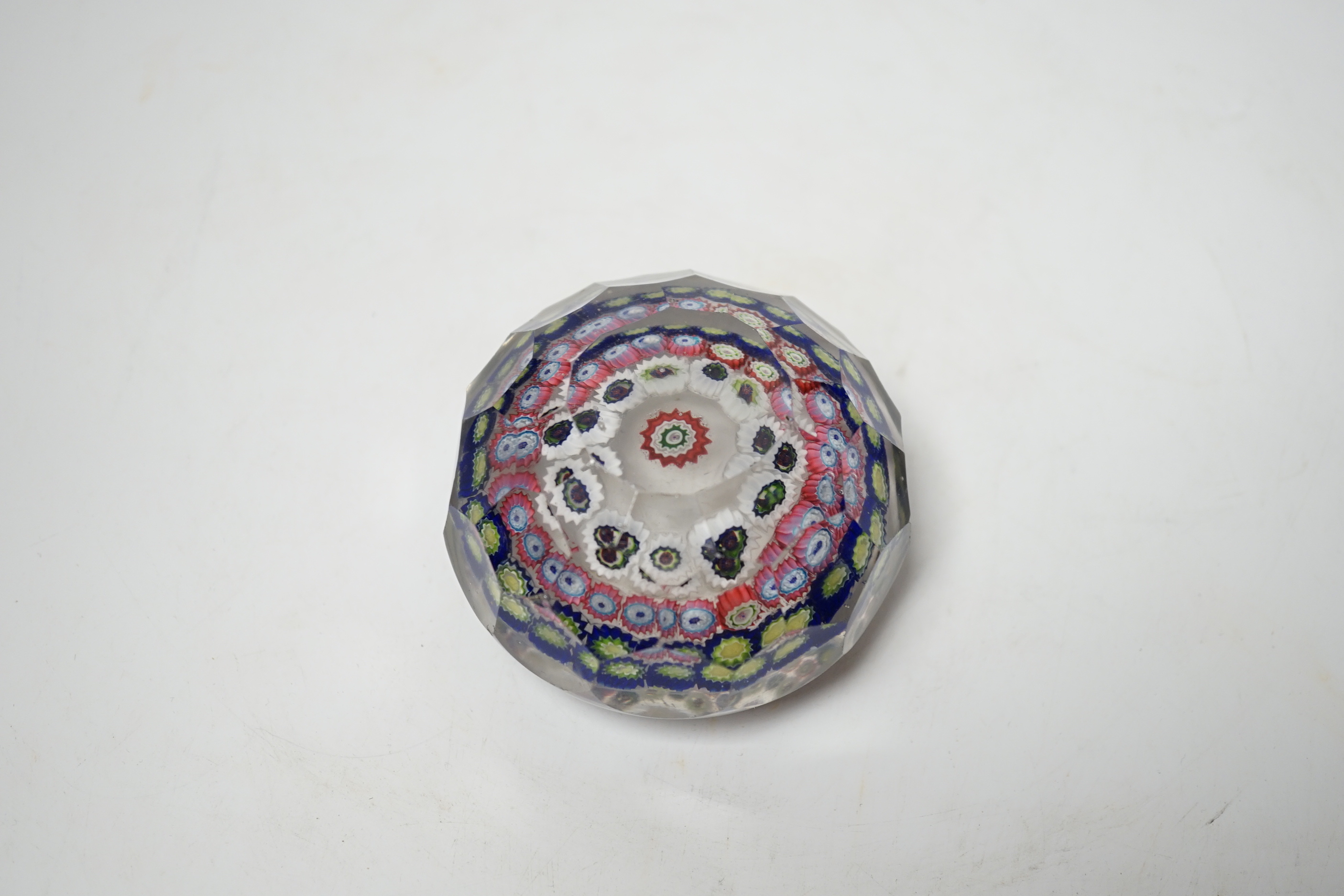 A 19th century French faceted glass paperweight, 8cm diameter